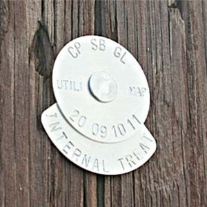 137 and 89 pole tag sample plain aluminum pole tag on a wood utility pole showing internal treatment
