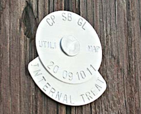 137 and 89 pole tag sample plain aluminum pole tag on a wood utility pole showing internal treatment