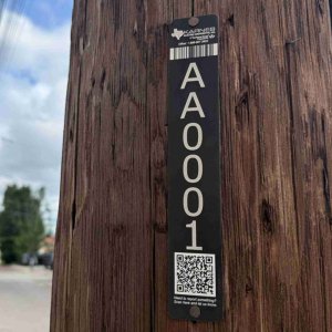 Karnes Power Pole Tag Example QR Coded power pole ID tag on a wood utility pole
