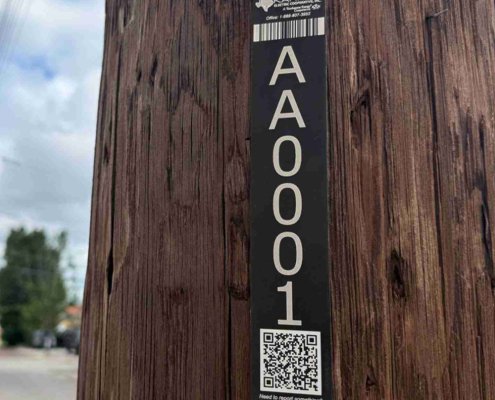 Karnes Power Pole Tag Example QR Coded power pole ID tag on a wood utility pole
